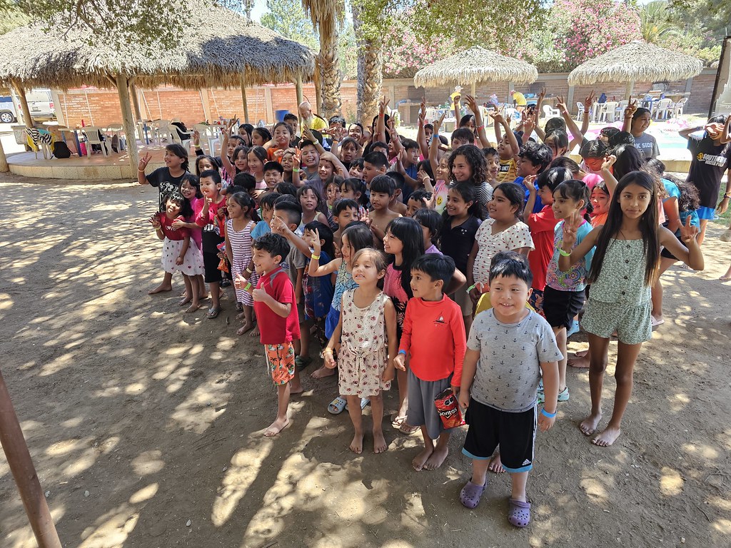 Children and volunteers gathered outside the ministry